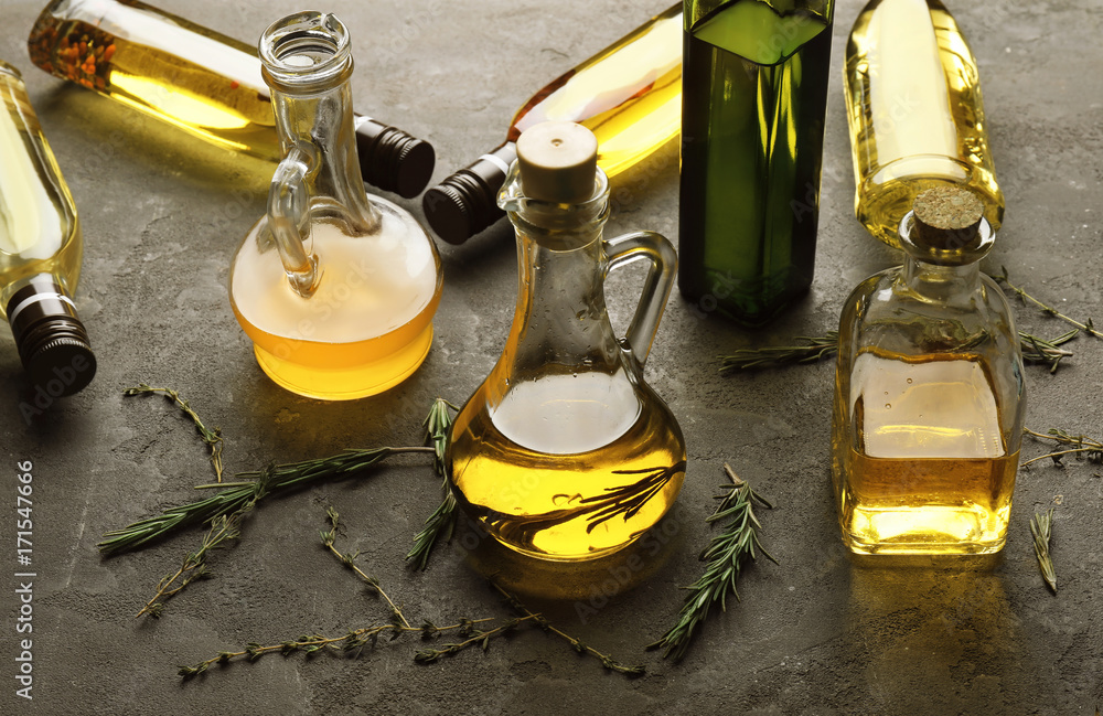 Bottles with different cooking oil on table