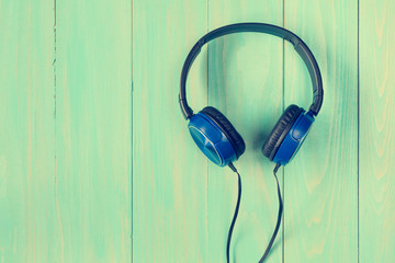 Stereo headphones on wooden background