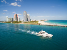 Aerial View Of South Miami Beach With Boat Sailing Next To The City Line