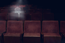 Transparent Ghost Little Girl Appears Between Vintage Seat In Movie Theater, Horror Film, Halloween Horror Concept.