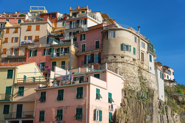 Magnificent daily view of the Manarola village in a sunny summer day. Manarola is one of the five famous villages in Cinque Terre (Five lands) National Park. Liguria, Italy, Europe