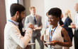 © Syda Productions - business people with conference badges and coffee