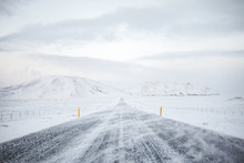 Straight Road In Snow Covered Landscape And Stormy Weather, Route 1, Western Iceland