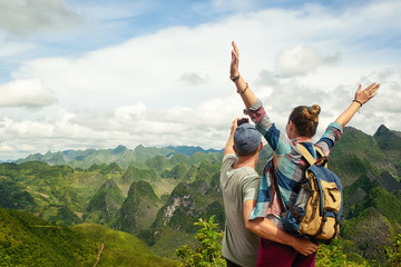 couple of tourists making selfie on background of karst mountains.