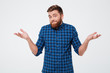© Drobot Dean - Confused young bearded man standing