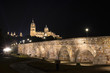 Night view of Salamanca Old and New Cathedrals from Roman Bridge over Tormes River, Community of Castile and Leon, Spain. 