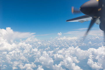 Wall Mural - clouds and sky with wing of an airplane.