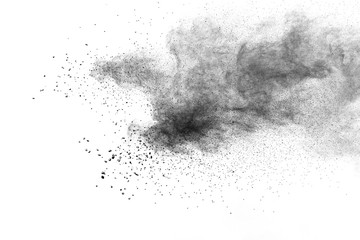 Wall Mural - Black powder explosion against white background.