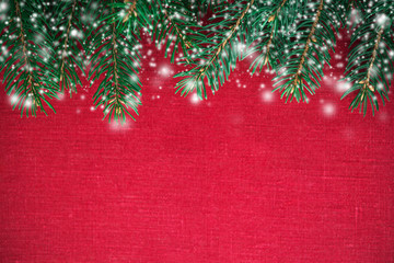 Wall Mural - christmas background with xmas tree and snow on red canvas background. merry christmas greeting card