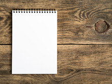 Open Notepad With A Clean White Page On Wooden Table, Top View