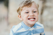 © Amir Kaljikovic Photography/Stocksy - Cute little boy grinning and showing his teeth