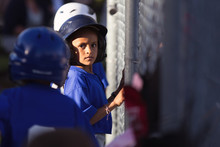 Young Girl With An Intent Look While Waiting To Bat