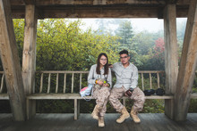 Young Couple Sitting On The Bench