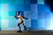 © katyshka - Cute little boy on roller skates running against the blue graffiti wall
