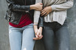 © WAVE/Stocksy - Close up of holding hands between two girl friends