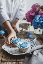 Woman Is Taking Blue Cupcake
