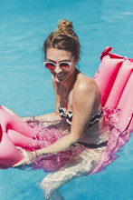 Woman On A Water Mattress At The Swimming Pool