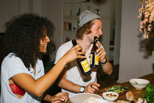 Snapshot Of Two Friends Toasting With Beer And Having A Laugh