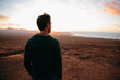 © AlejandroMCB photo & film/Stocksy - Back view of man watching seascape