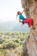 © RG&B Images/Stocksy - Young woman rock climbing in summer