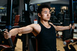 © Maa Hoo/Stocksy - Man doing chest exercises with a fitness machine
