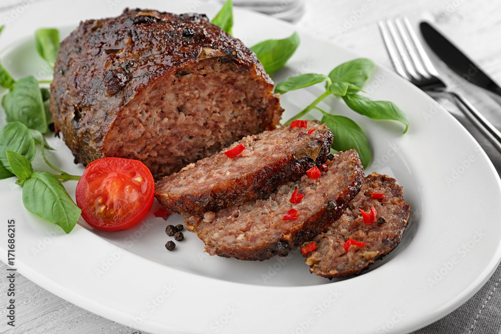 Tasty baked turkey meatloaf on plate, closeup