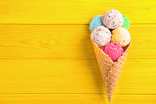 Composition With Colorful Ice-cream Scoops And Waffle Cone On Wooden Background