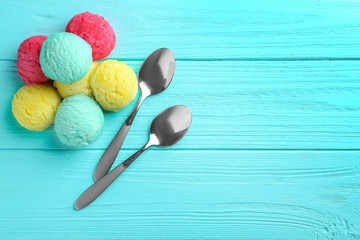 Poster - Composition with colorful scoops of ice-cream and spoons on wooden background