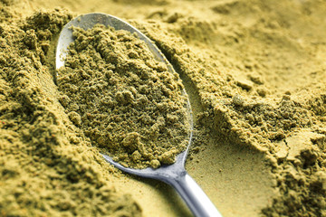 Poster - Metal spoon in hemp protein powder, closeup