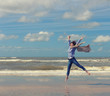 © papa - Happy young woman jumping on background of the sea.