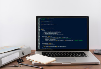Wall Mural - program code on computer screen. programming and coding technology background.