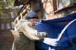 © Svyatoslav Lypynskyy - Homeless old man in search for food. Poor tramp hungry, rummaging for some food in garbage.