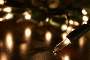 christmas lights on the table getting ready to be put up. bright white twinkly lights for the holida