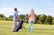 © Photocreo Bednarek - Active senior couple playing golf on a course.
