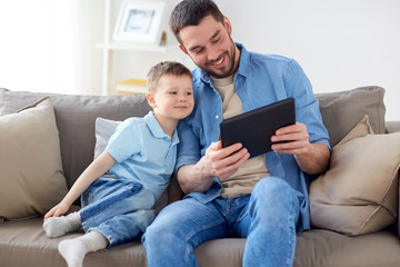 Poster - father and son with tablet pc playing at home