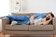 © Syda Productions - happy father and son sleeping on sofa at home