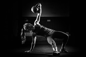woman athlete exercising with kettlebell
