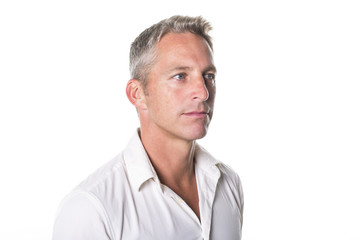 Wall Mural - Portrait of confident mature man standing on white background