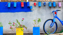Decoration Wall In Greek Style With Flower And Old Rusty Bike.