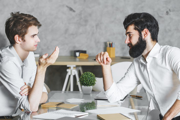 Poster - Two focused men working on project together