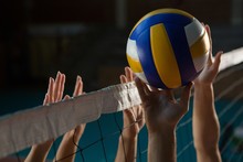 Cropped Hands Of Players Practicing Volleyball