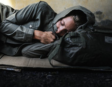Homeless Woman Sleeping On The Street