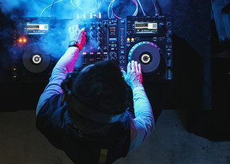 Wall Mural - DJ is on a mixer station