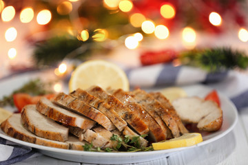 Poster - Plate with delicious sliced turkey breast against blurred lights