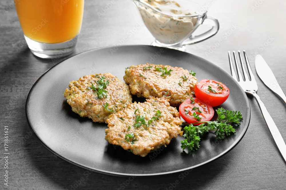 Delicious broccoli pancakes with cherry tomato and fresh parsley on dark background