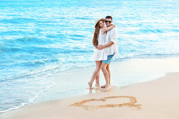 Wall Mural - Happy young couple on sea beach