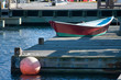 red rowboat on dock