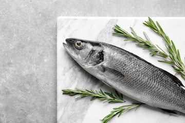 Poster - Fresh fish with rosemary on gray background