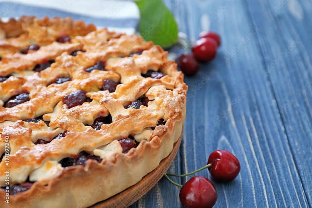 Tasty cherry pie on wooden table, closeup