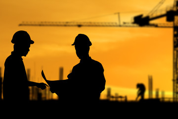 Silhouette images of construction sites are underway and workers are working